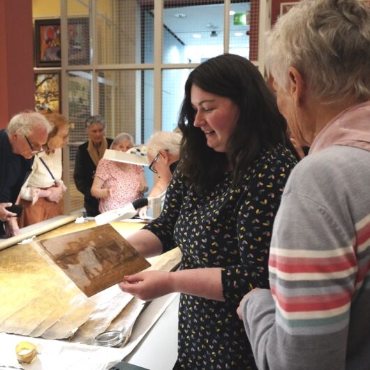 two women looking at a photograph