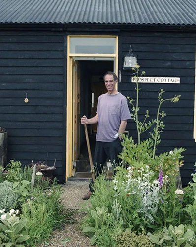 Portrait of Derek Jarman in his garden